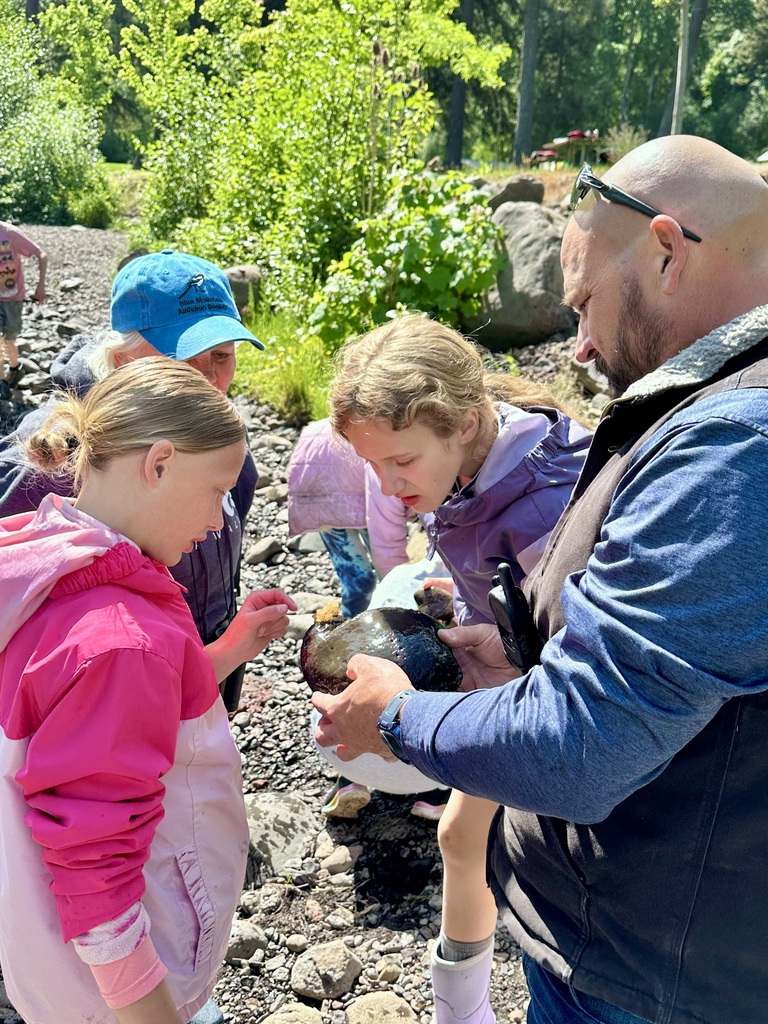 students outside looking at rock