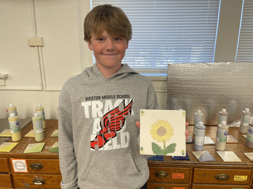 student with painted tile