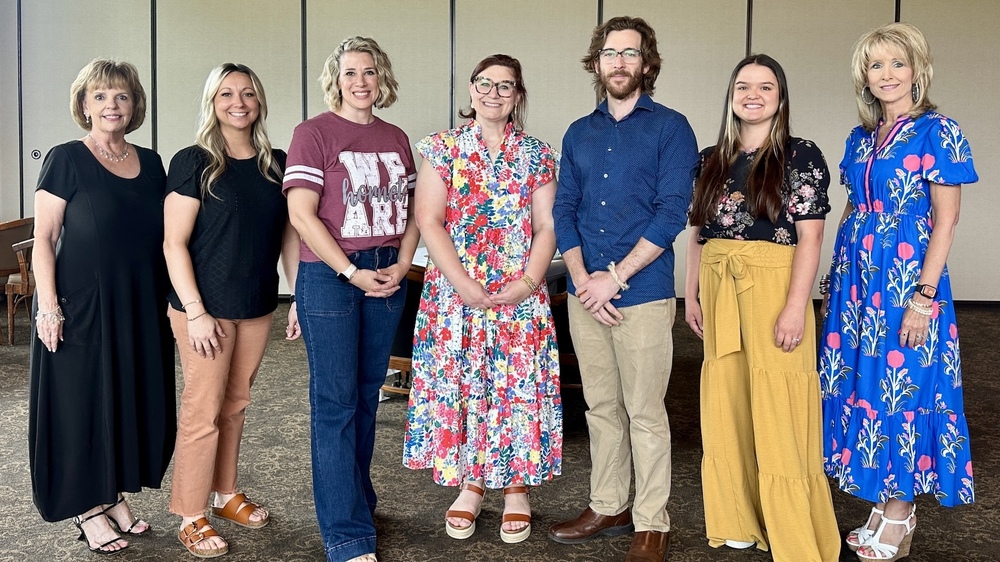 Seven Athens ISD educators and administrators stand side by side indoors for a group photo. From left are Superintendent Dr. Janie Sims, Mindy Boyle, Sunshine Feagins, Rachel Wimberley, Spencer Hill, Morgan Burleson and Deputy Superintendent Ginger Morrison.