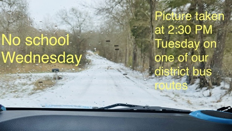 Picture of a snow or ice covered country road with woods on either side. words on Photos say no school Wednesday. Picture taken at 2:30 PM Tuesday on one of the district bus routes