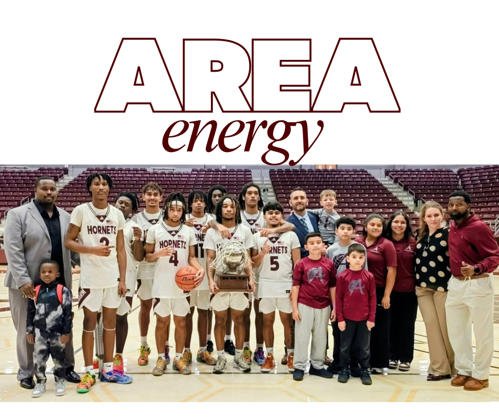 Photos shows basketball players in white uniforms holding a trophy, flanked by coaches, trainers and other supporters