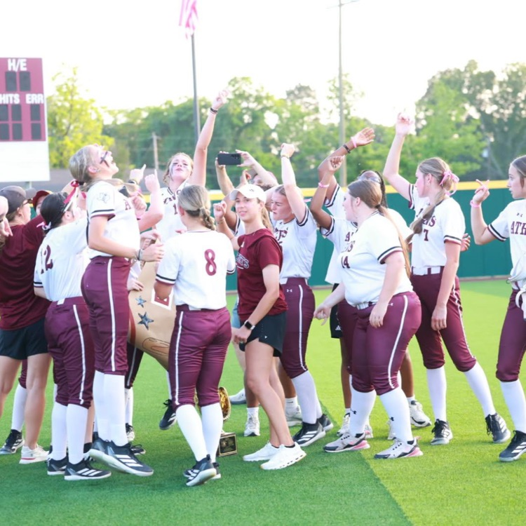The Lady Hornets are shown celebrating on the field