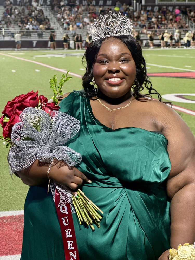 Photo of young woman in green dress wearing a crown  