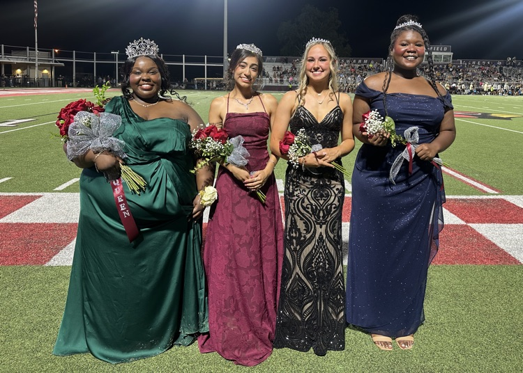 photo of four women wearing formal gowns and wearing crowns  