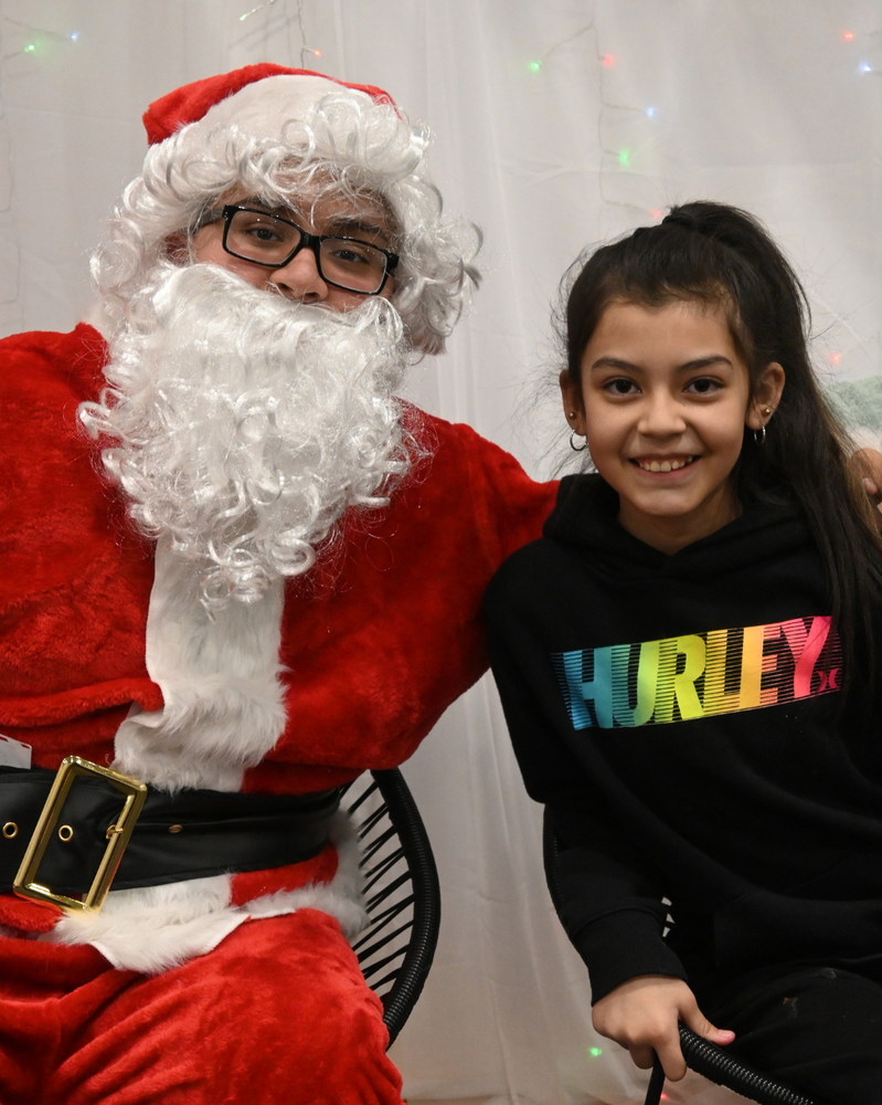 student smiles with santa