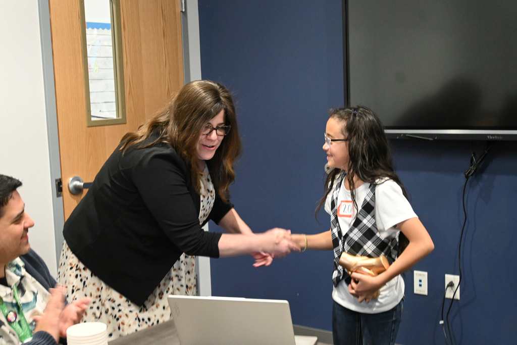 student shakes hand with principal