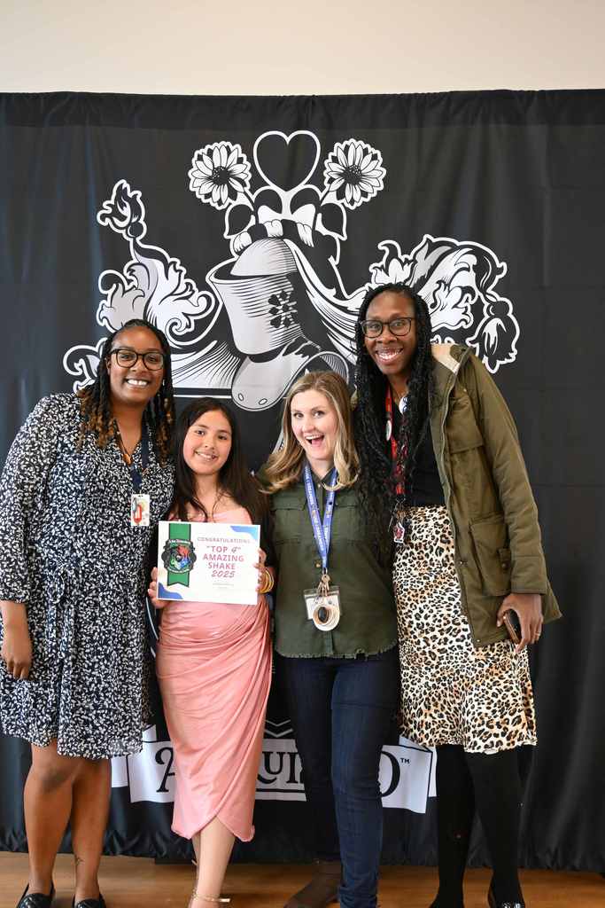 student smiles with teachers