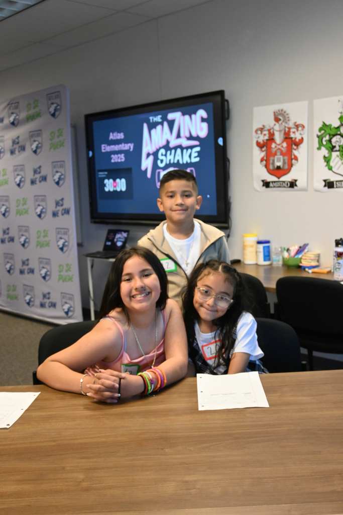 three students smile