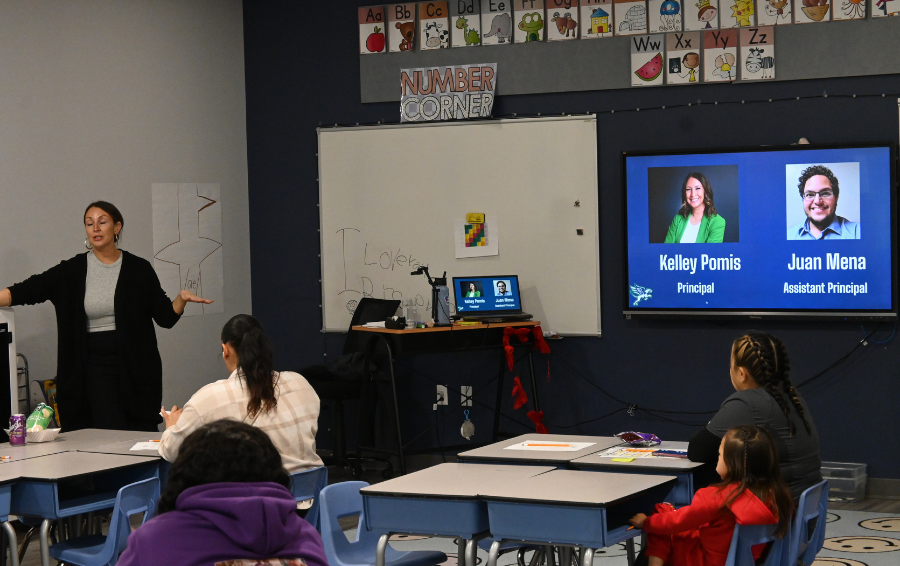 families sitting in classroom listening to presentation
