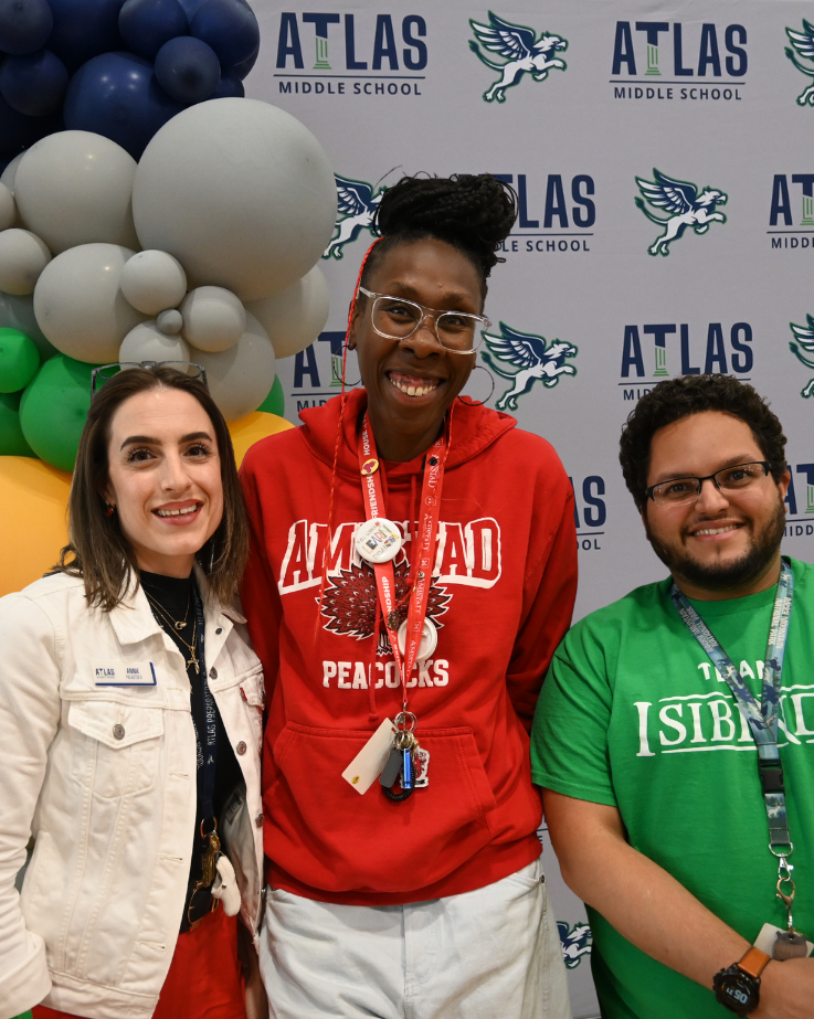 three staff members smiling