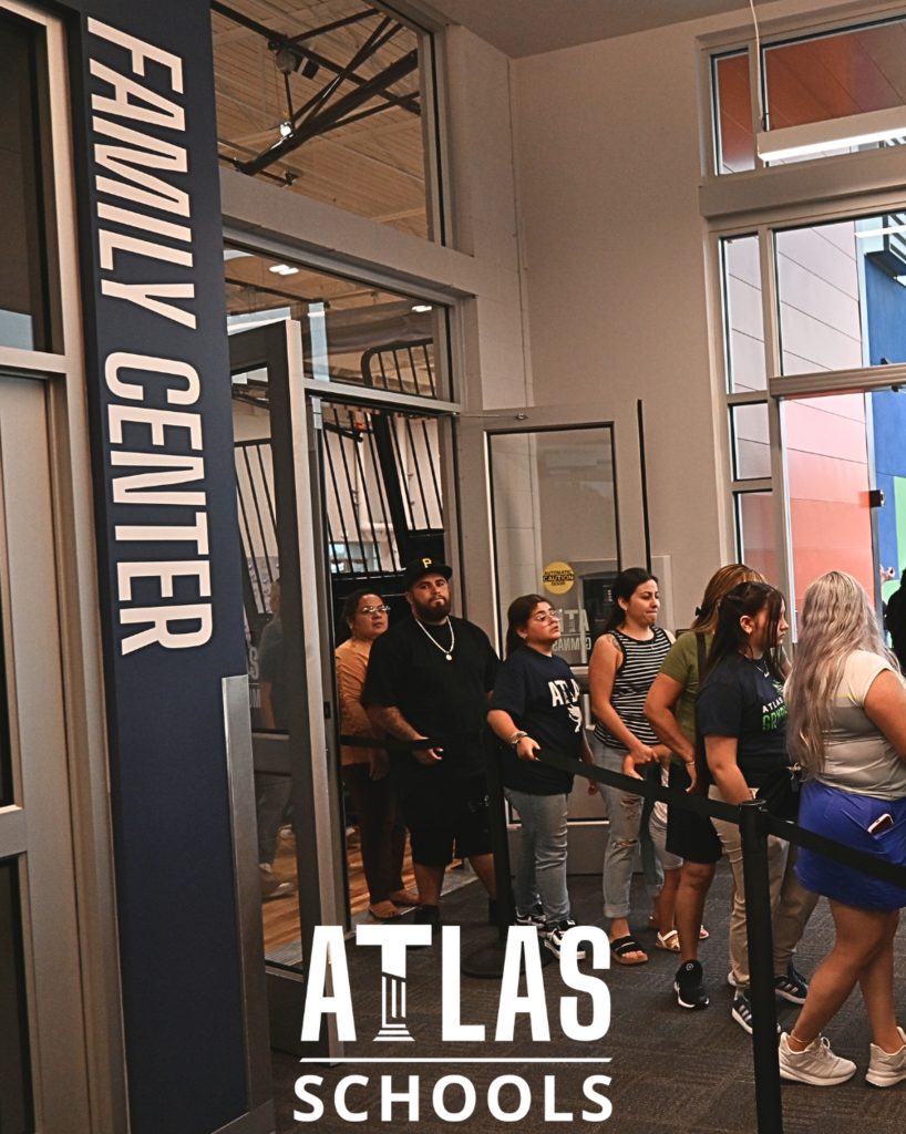 people standing in a line with the words family center on the wall