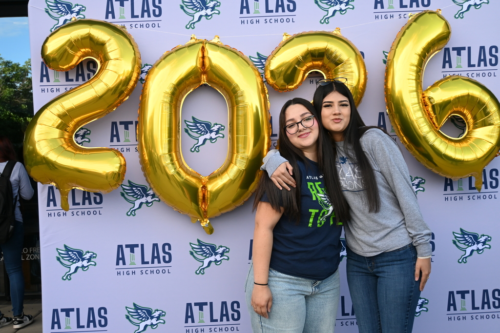 two girls smile with 2026 in background
