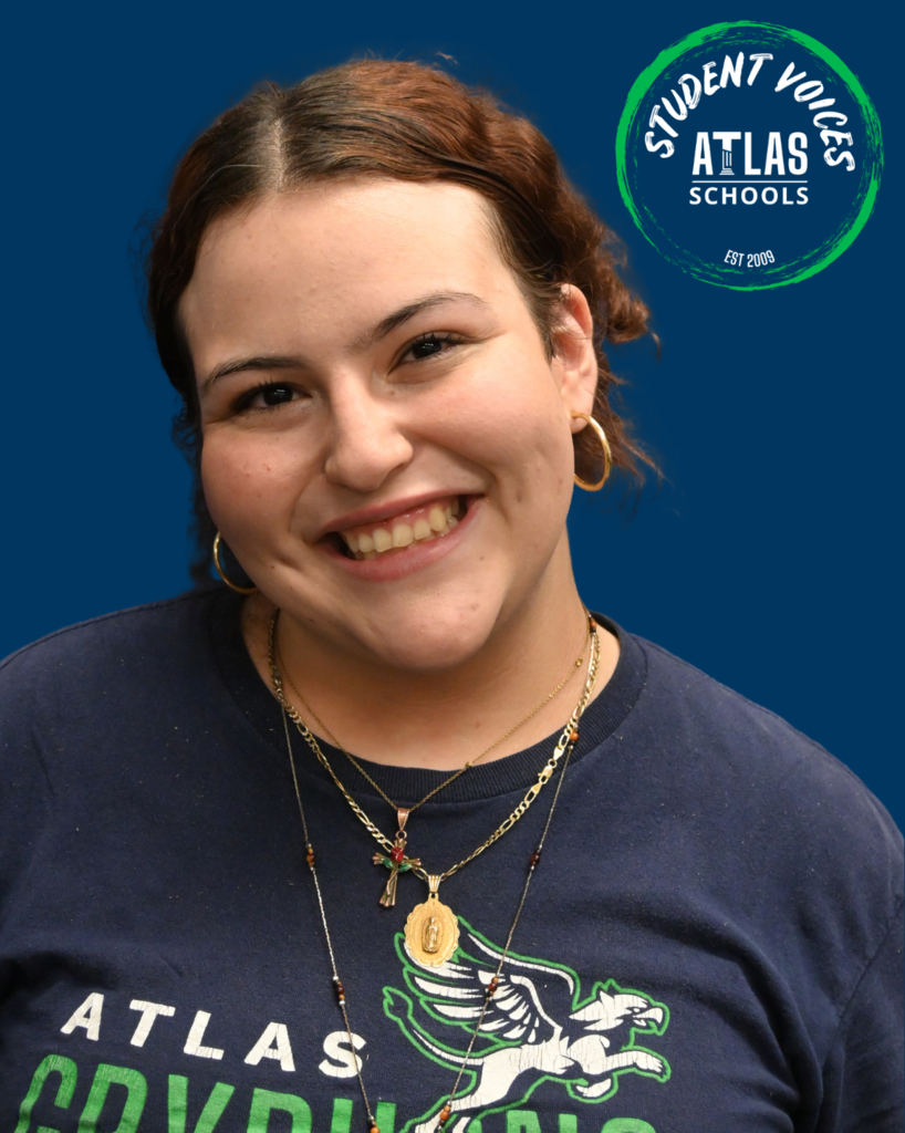 Student smiling with student voices and atlas logo