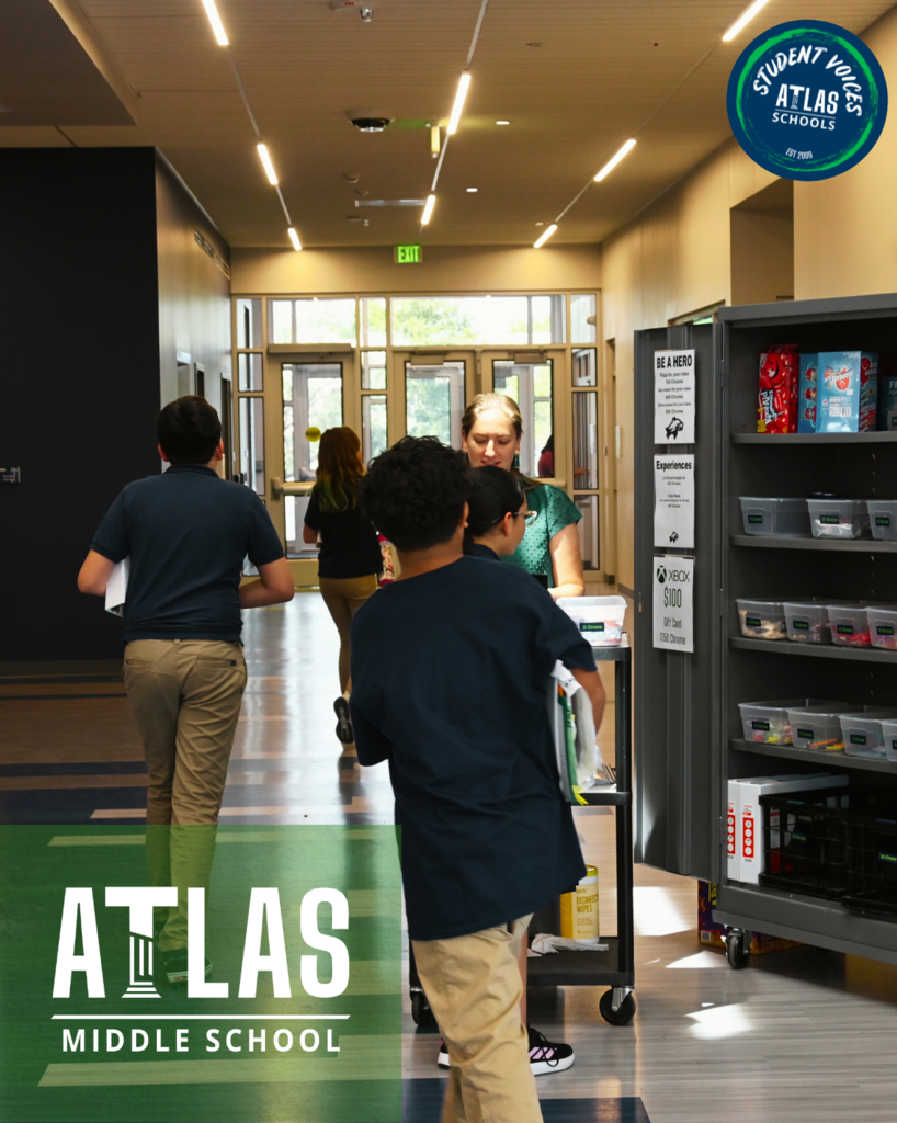 Teacher standing with students, in front of chrome store. Atlas Middle School logo.