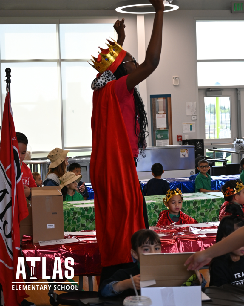 woman cheers in red cape and crown