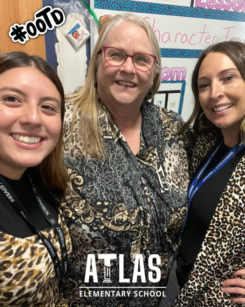 three teachers smile with leopard prints on