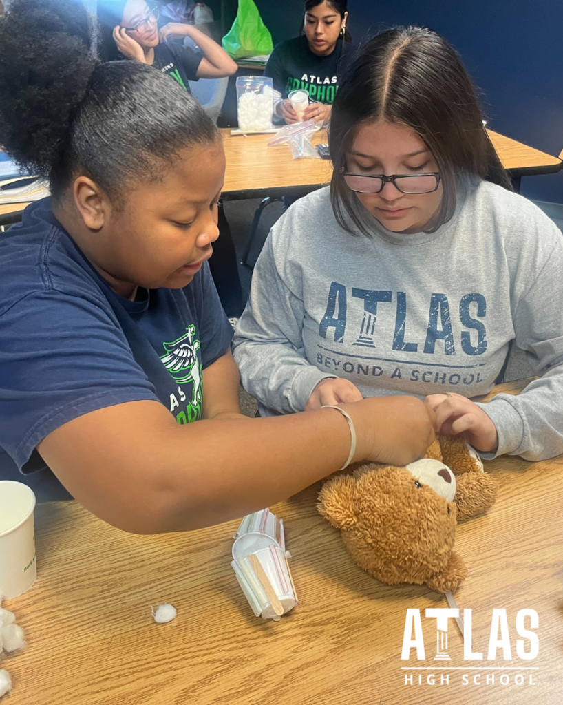 student works with teddy bear