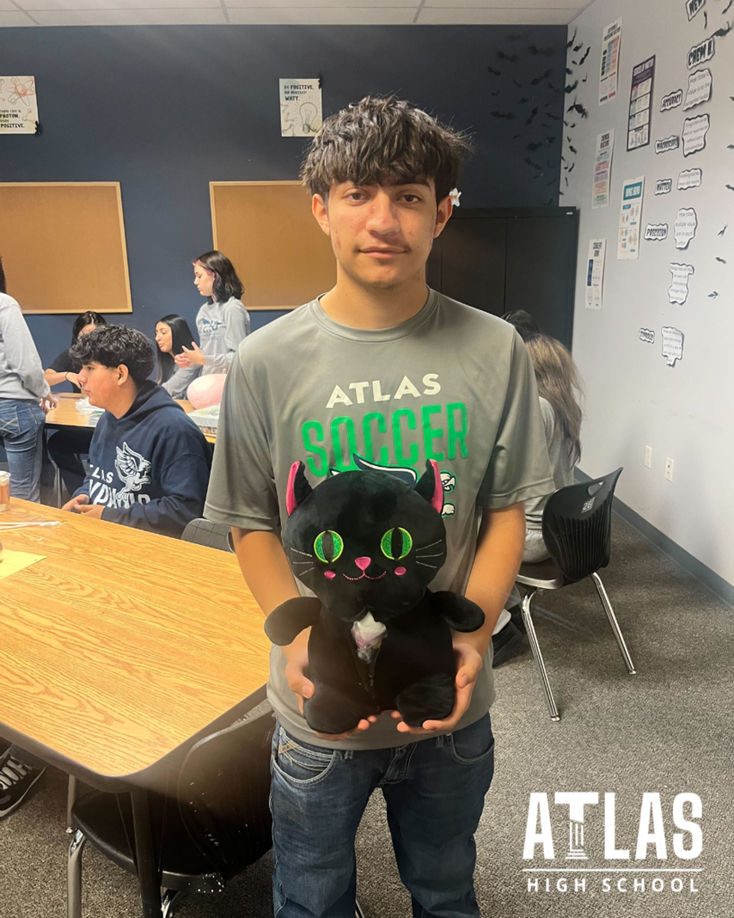 student smiles with stuffed animal