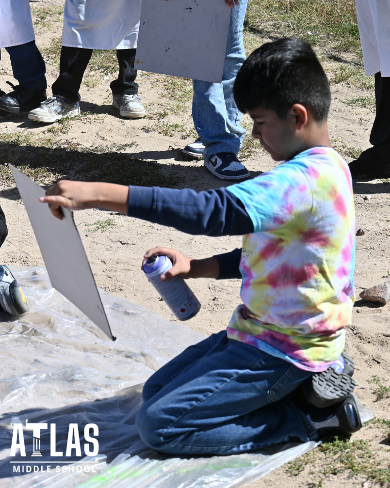 student uses spray paint