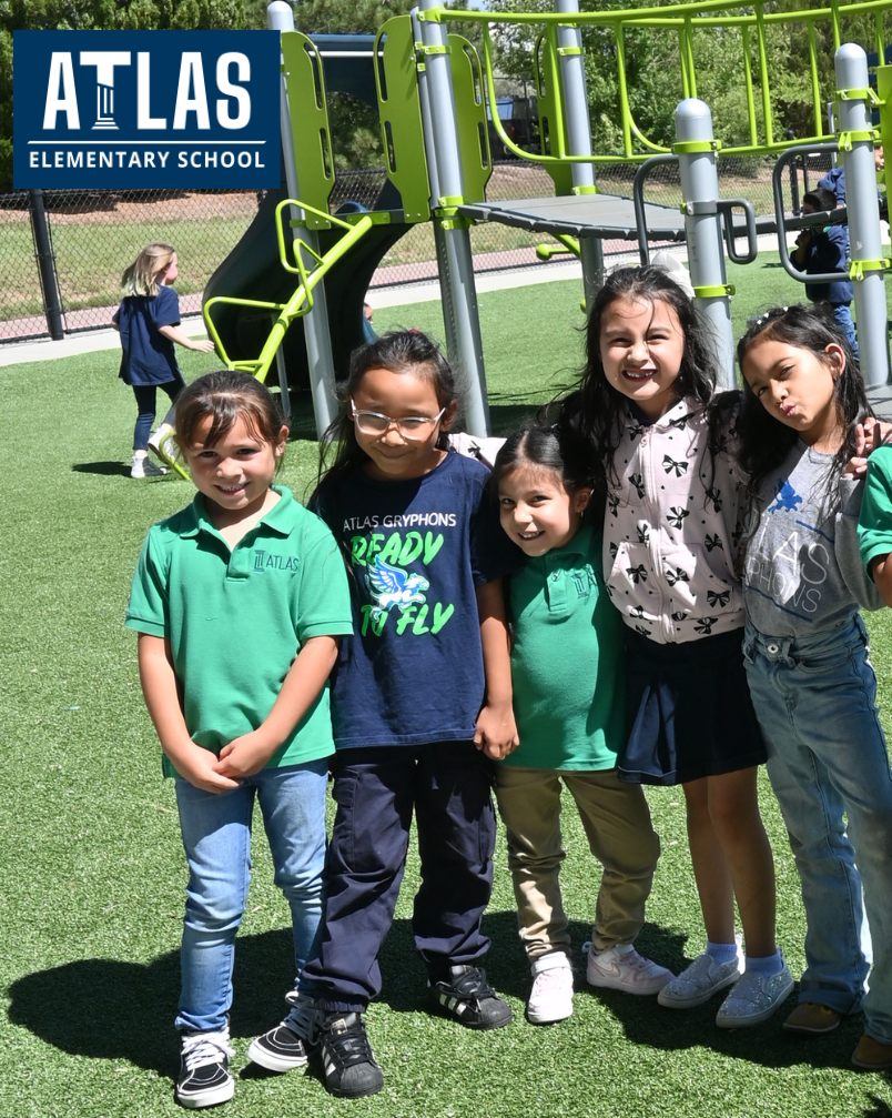 Girls stand on playground smiling