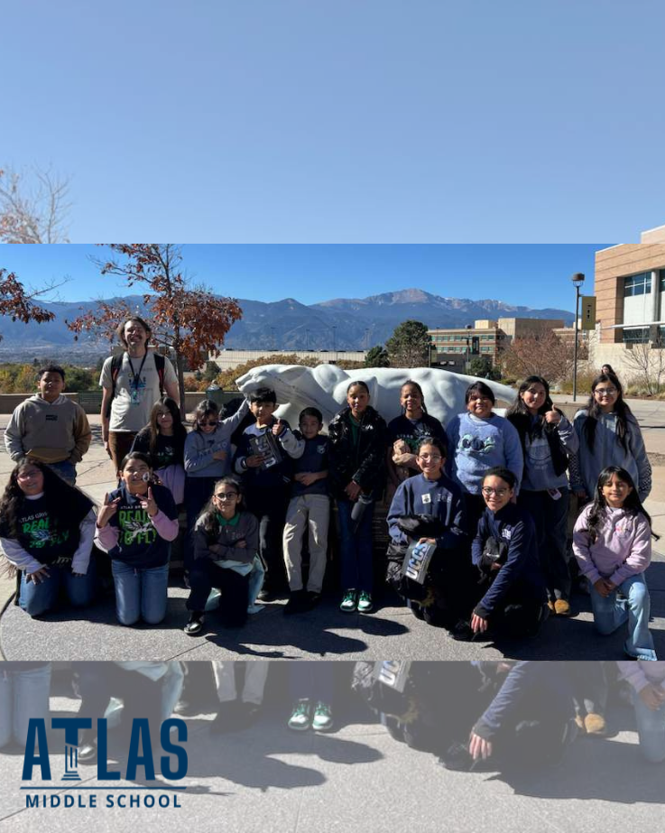 students smile at UCCS with mountains in background
