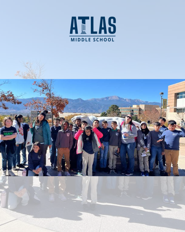 students smile at UCCS with mountains in background