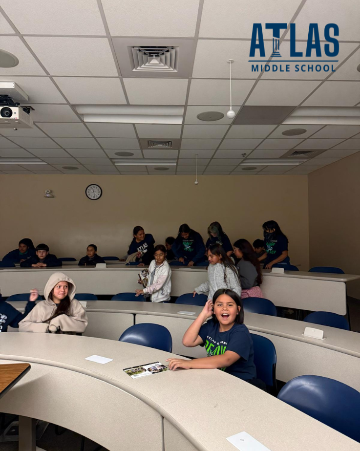 students smile at UCCS while sitting around tables