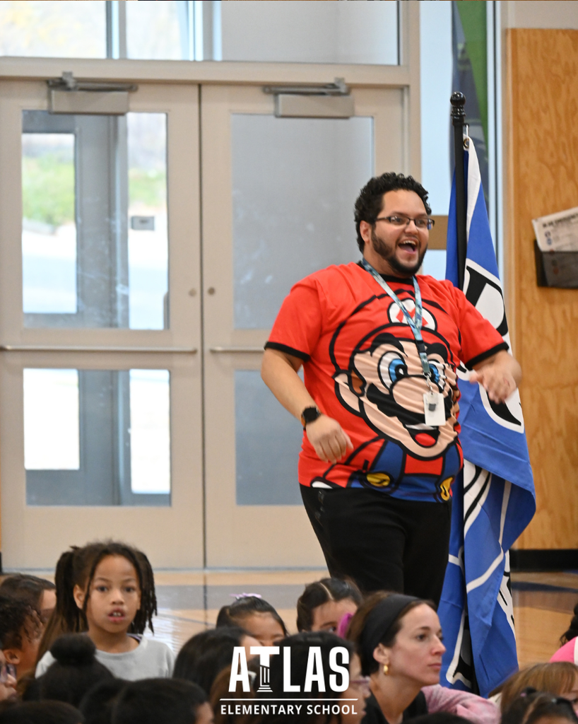 man smiles with mario bros shirt