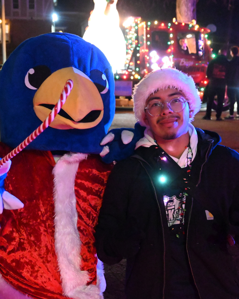 gryphon mascot smiles with atlas student