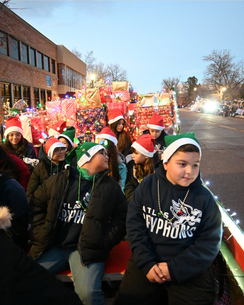 students smile while riding float