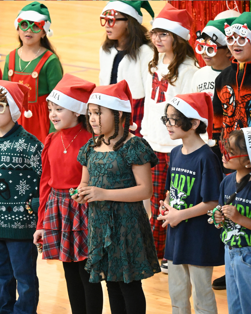 students smile while singing in holiday attire