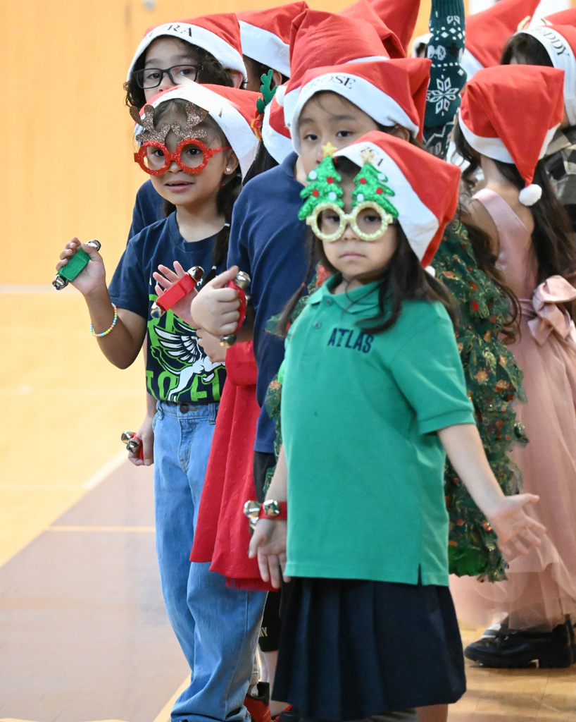 students smile while singing in holiday attire