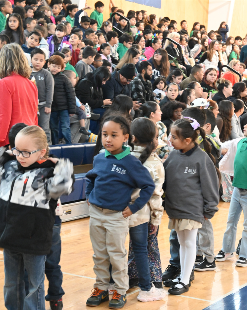 students smile while singing in holiday attire