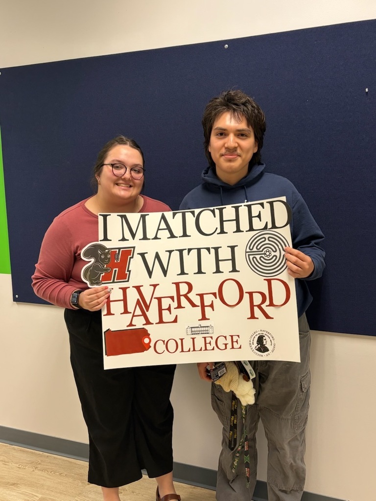 ERick stands with his high school guidance counselor, isabelle.