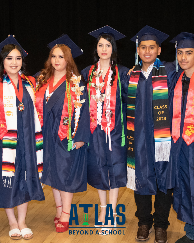 graduates smile with caps, gowns, ribbons
