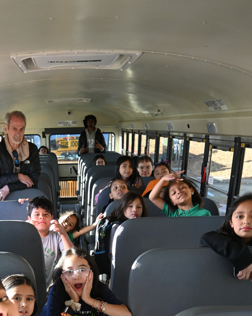 students smile on bus