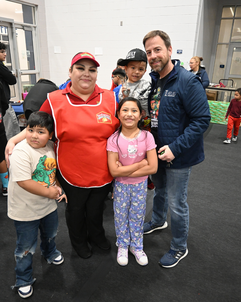 family smiles with high school principal mr. pomis