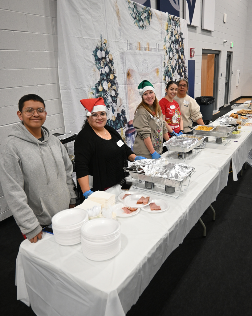 volunteers smile as they serve food