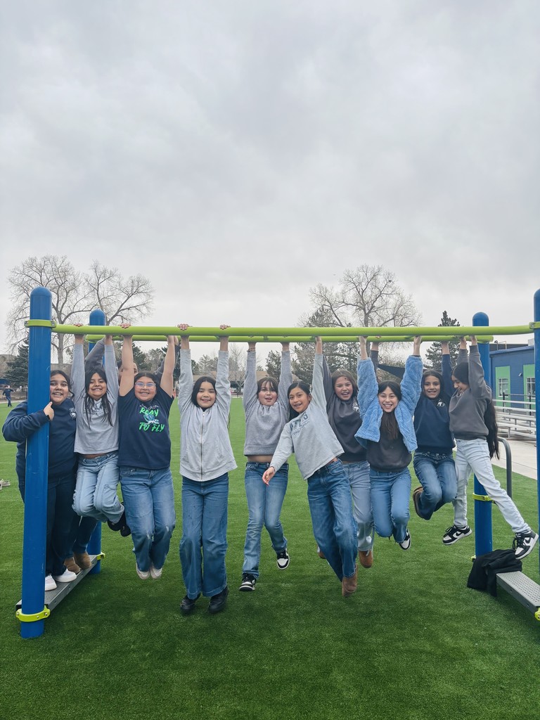 students play on new playground equipment