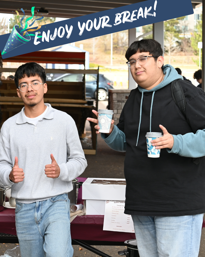 Two students give thumbs up