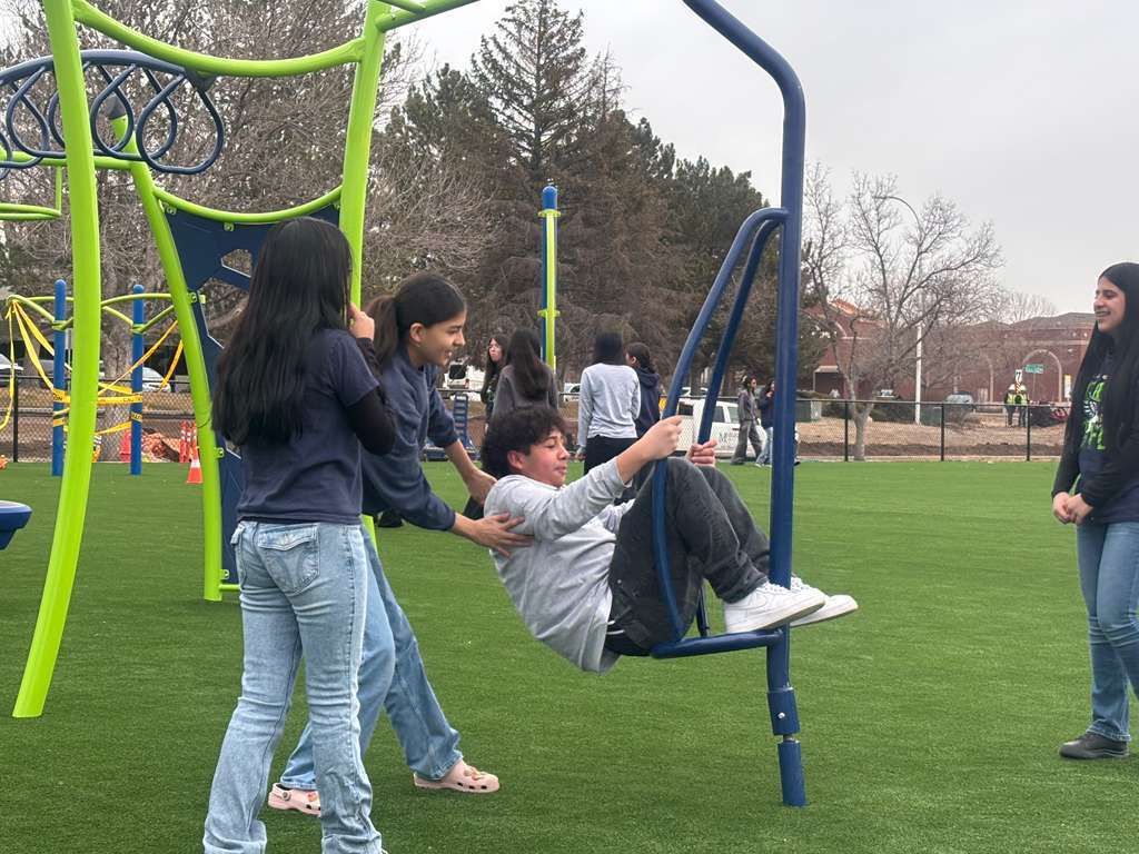 students play on new playground equipment