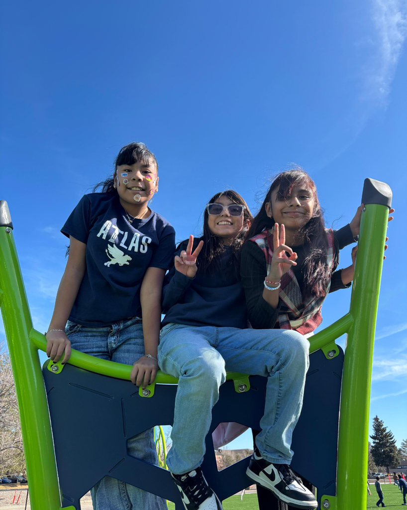 students smile with stickers on their faces