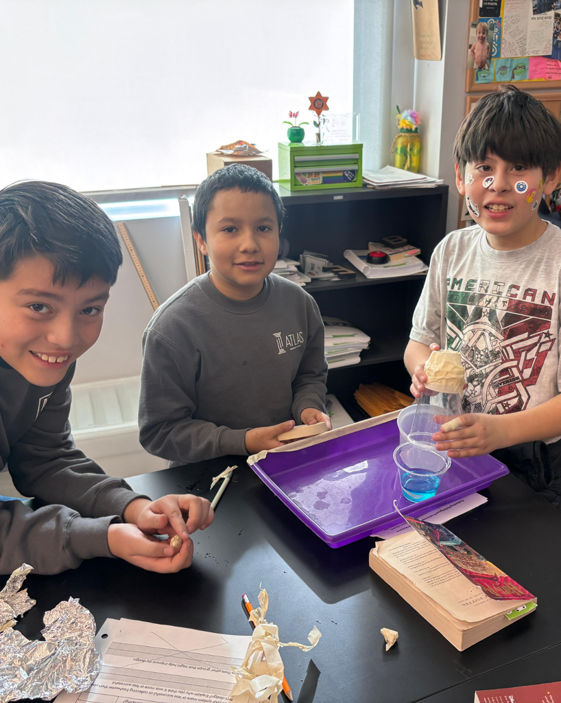 students smile with stickers on their faces