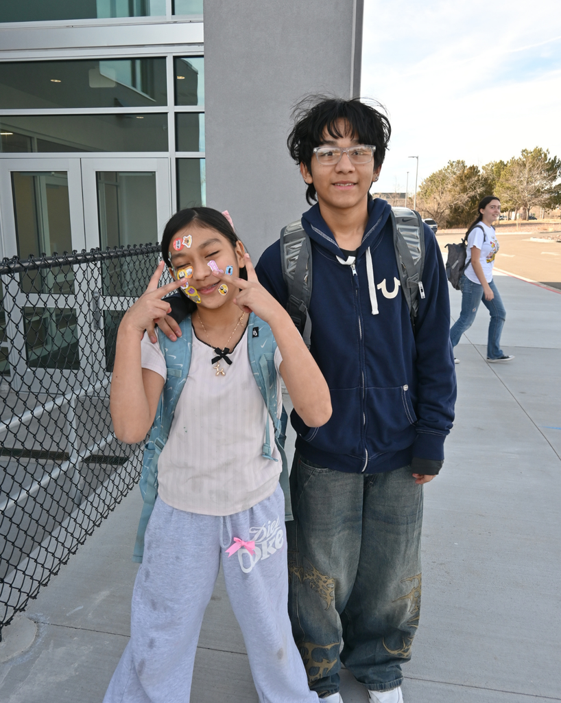 students smile with stickers on their faces