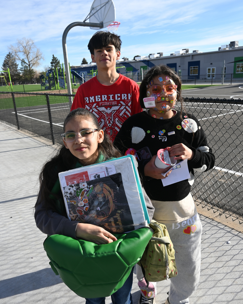 students smile with stickers on their faces