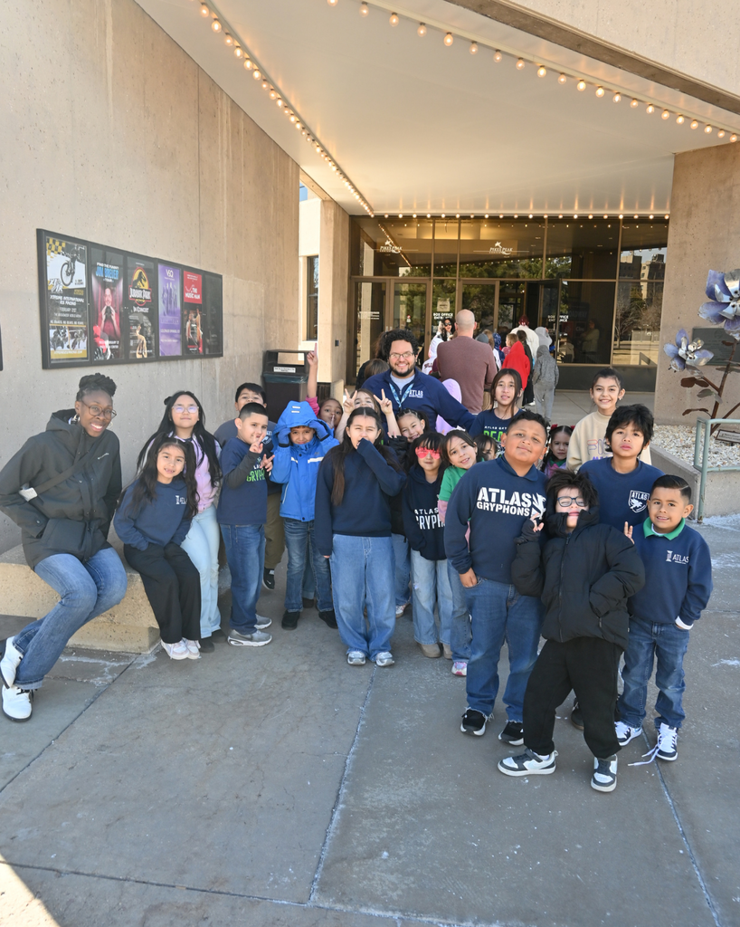 students smile outside of arts center