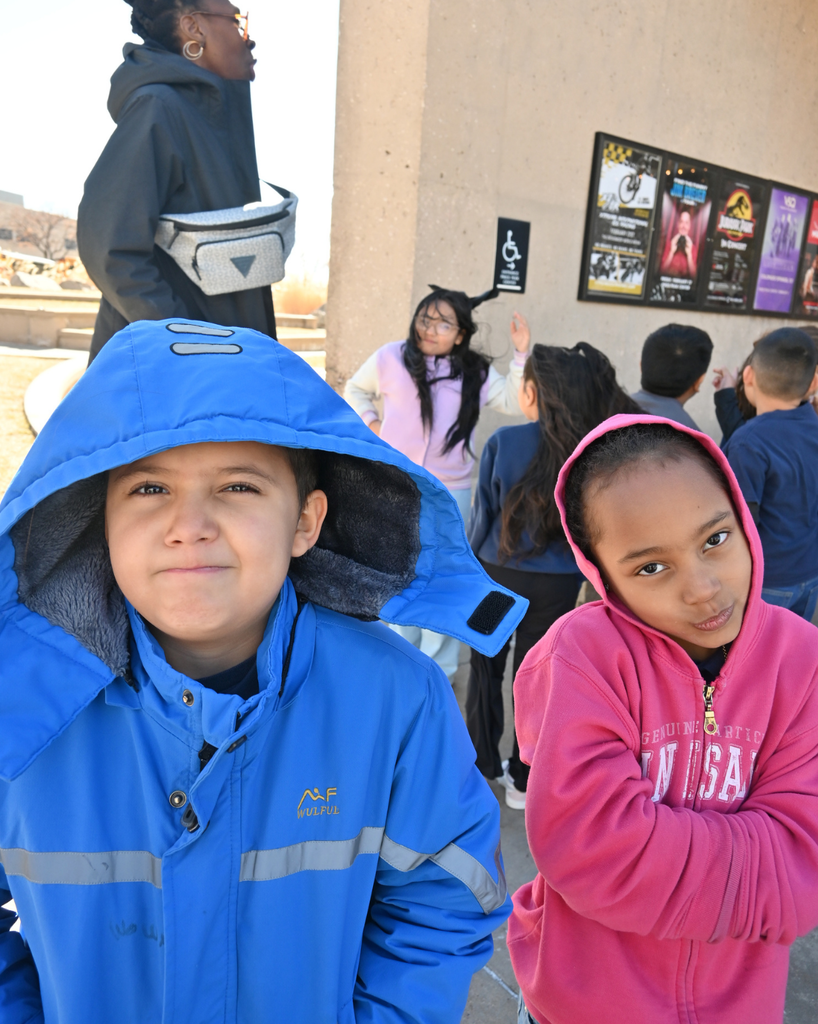 students smile while waiting for performance
