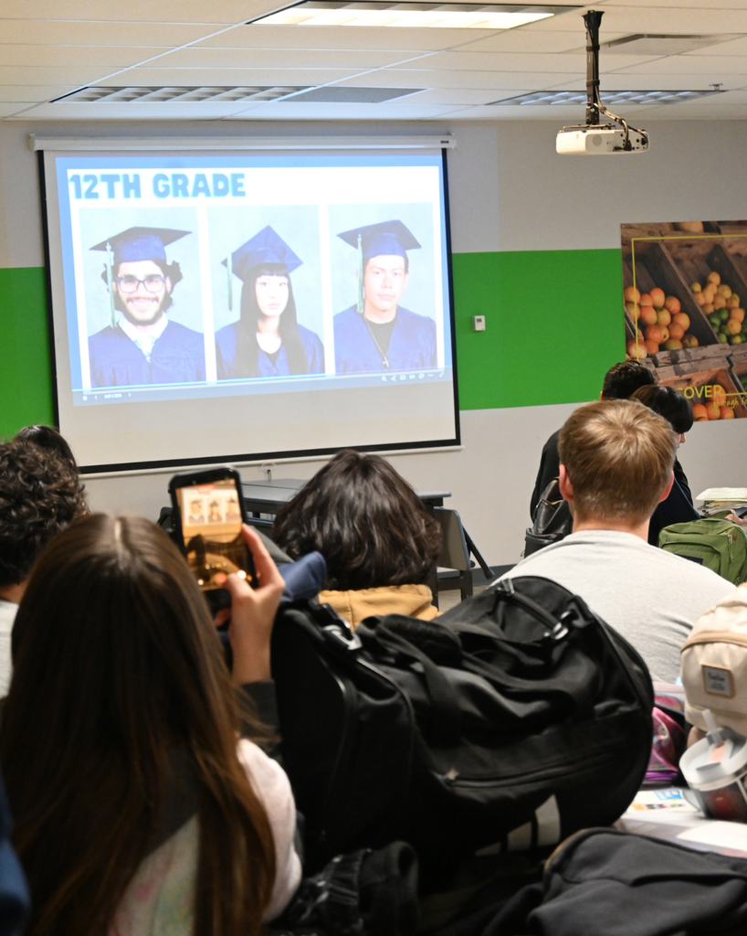 students look on at photos
