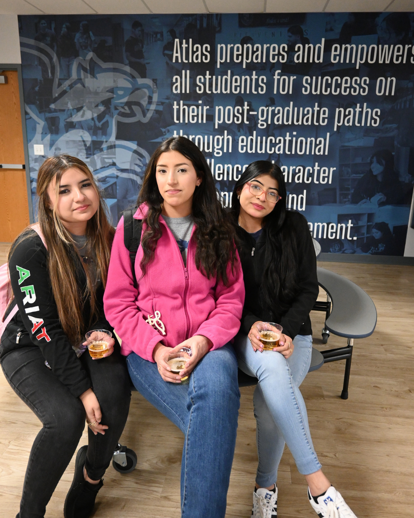 three students smile