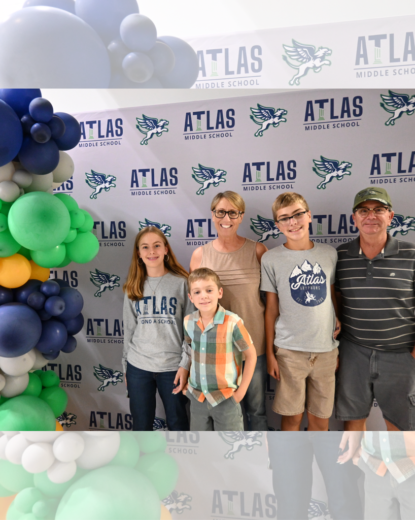 Family Smiles with Atlas in background